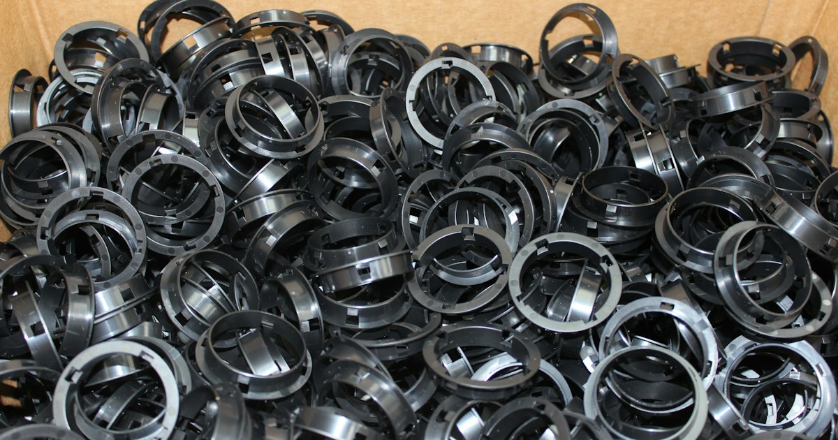 Bin of small steel rings with a uniform black coating